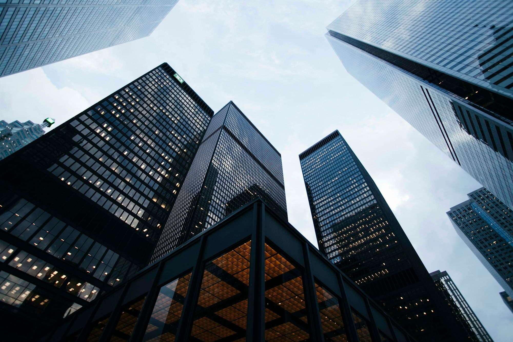 Glass towers rising above a city plaza